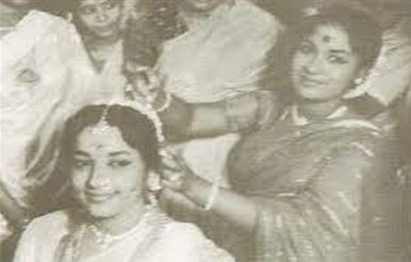 Savitri braiding Jamuna's hair on her wedding day