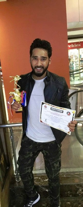 Anshul Jubli holding his award that he had won at the BodyPower India Open MMA Championships