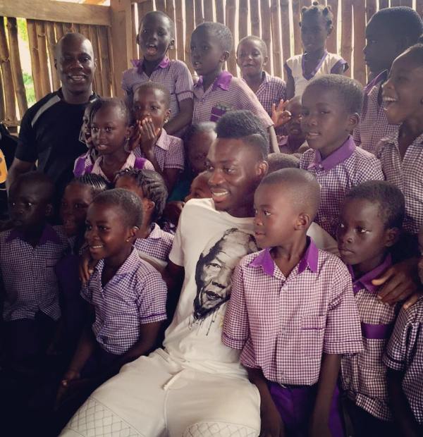Christian Atsu meeting children during a charity event