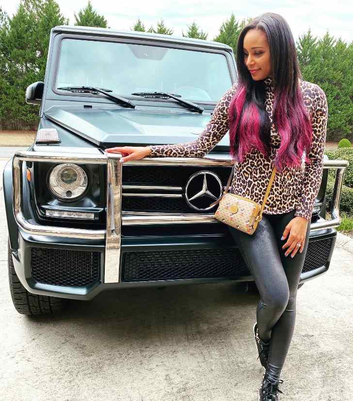 Cody Rhodes' wife posing in front of their G Wagon