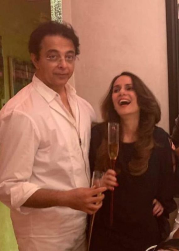 Jagdeep Advani (extreme left), and his wife, Genevieve Jaffrey, holding a glass of champagne