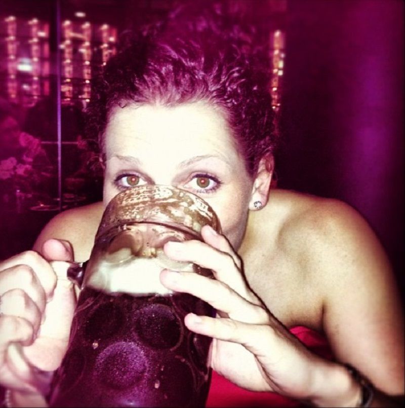 Laura Harris drinking beer