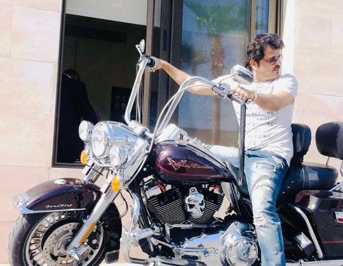 Rajesh Khattar sitting in his Harley-Davidson motorcycle