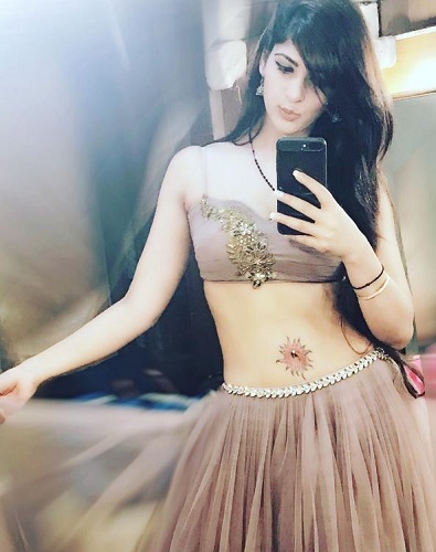Sapna Gill's tattoo and piercing on her belly button