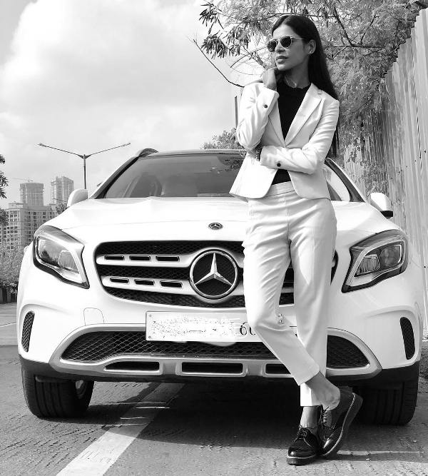 Tanu Chandel standing infront of her car