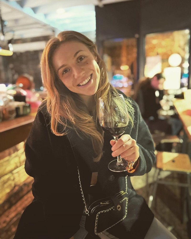 Tara Norris holding a glass of wine