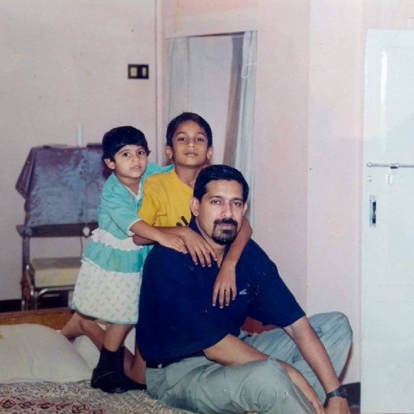 A childhood photograph of Arjun Radhakrishnan with his sister (left), and father (right)