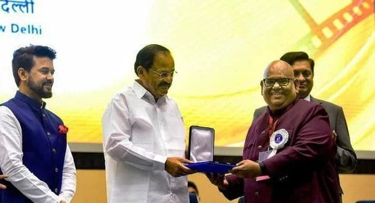 A photo of Satish Kaushik receiving the National Film Award