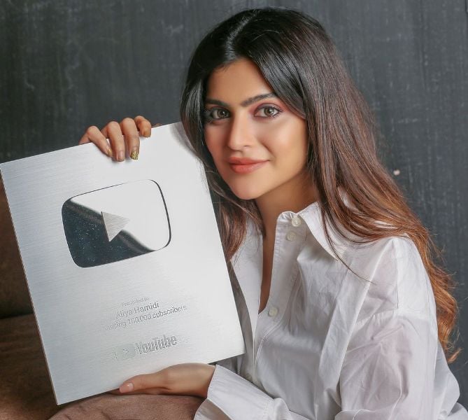 Aliya Hamidi holding the YouTube silver play button