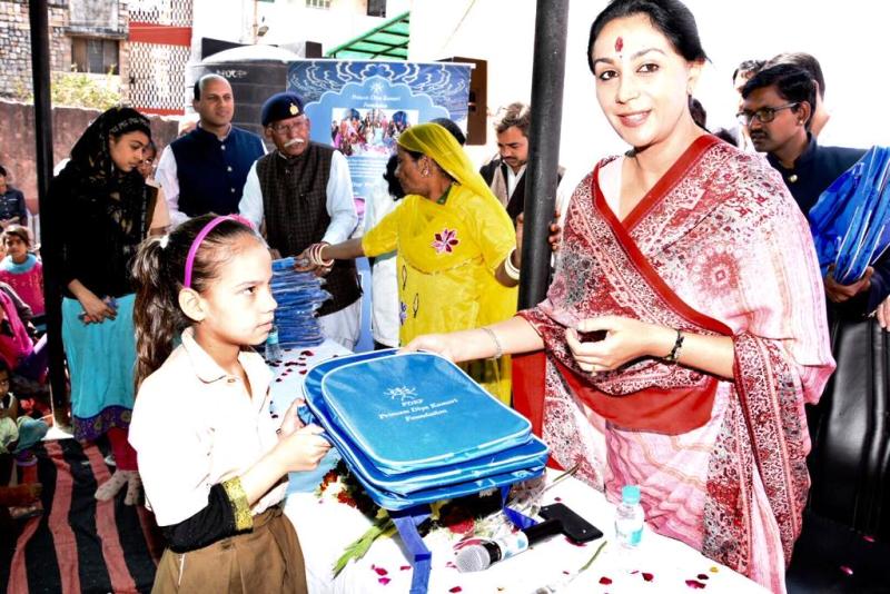 Diya Kumari distributing school bags to the children in the Jawahar Nagar slum area in Jaipur under Princess Diya Kumari Foundation (PDKF)'s education initiative