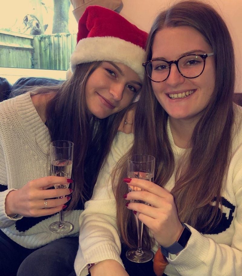 Lauren Bell (left) holding a glass of wine