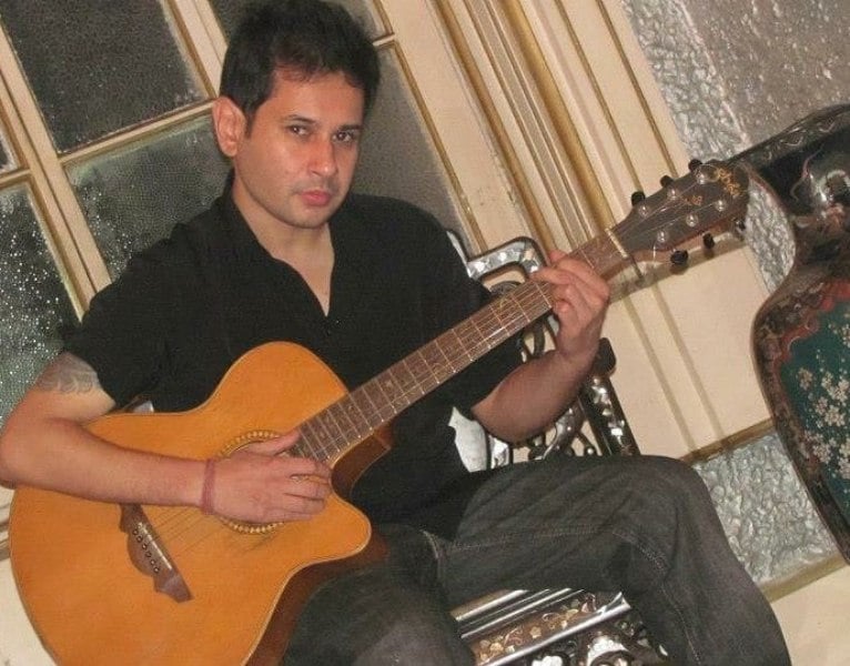 Pradyot with a guitar