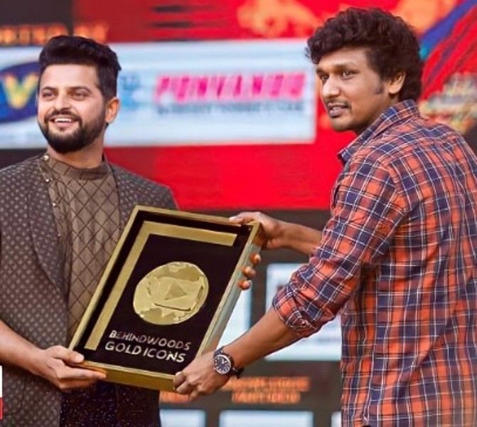 The Indian cricketer Suresh Raina presenting the Talent of the Decade Award to Lokesh Kanagara at the Behindwoods Gold Medals Awards for Lokesh's contribution to the Tamil film industry