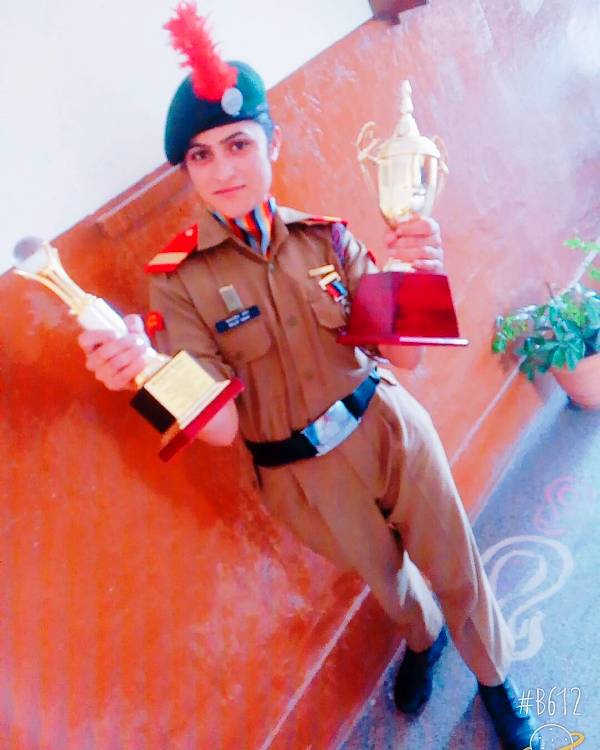 A picture of Baljeet Kaur with the awards that she received at the NCC