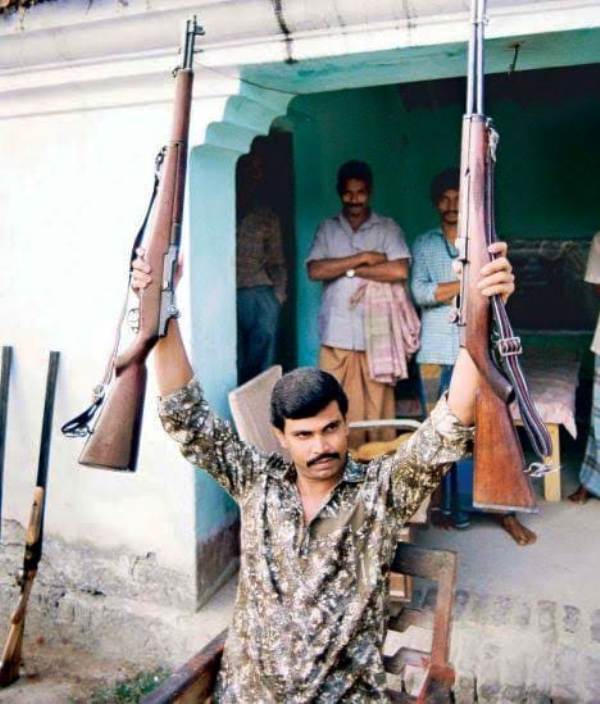 An image of Anand Mohan Singh holding his rifles