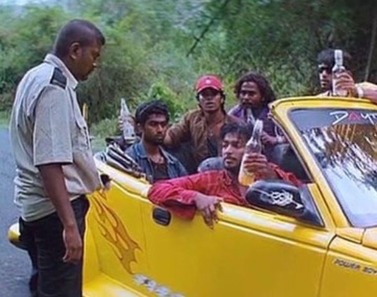 Kalaiyarasan Arjun (in red shirt) in a still from the film Nandalala (2010)