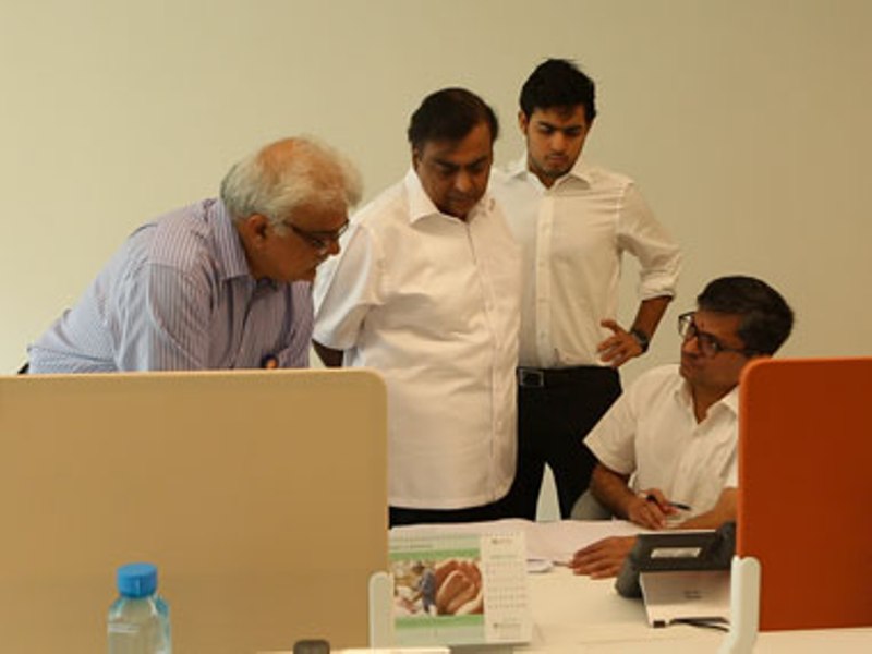 From left: Sanjay Jog (human resource head), Mukesh Ambani, Akash Ambani, and Manoj Modi at the Reliance Jio open office on the 7th floor of 'TC22' building at the sprawling Reliance Corporate Park in Mumbai
