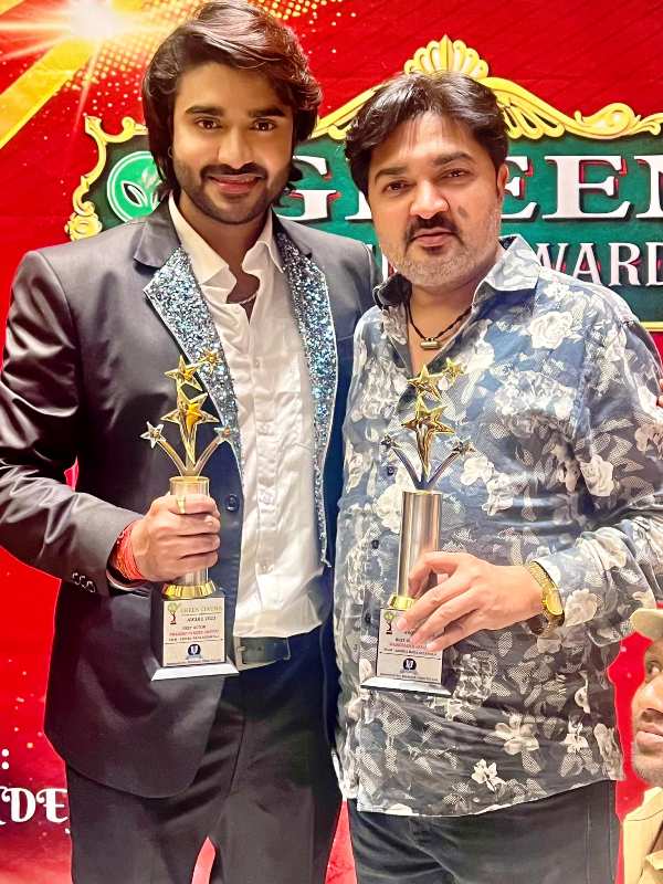 Pradeep and his father holding their Green Cinema Award