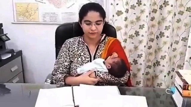 Saumya in office with her newborn daughter