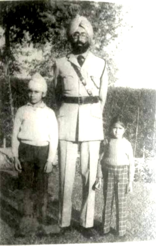 Simranjit Singh Mann in his police uniform posing for a picture with his children in Faridkot