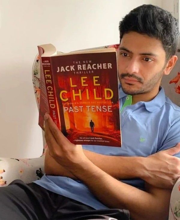 A photo of Arjun Chakrabarty reading a book