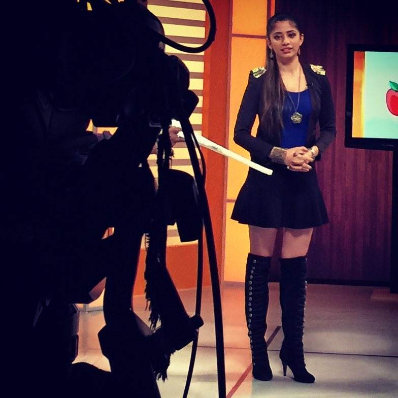 A photo of Snehal Rai hosting a TV show