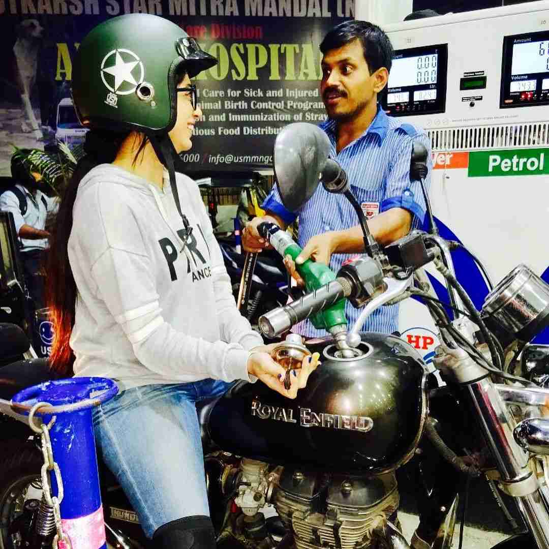 A photo of Snehal Rai (left) riding a motorcycle