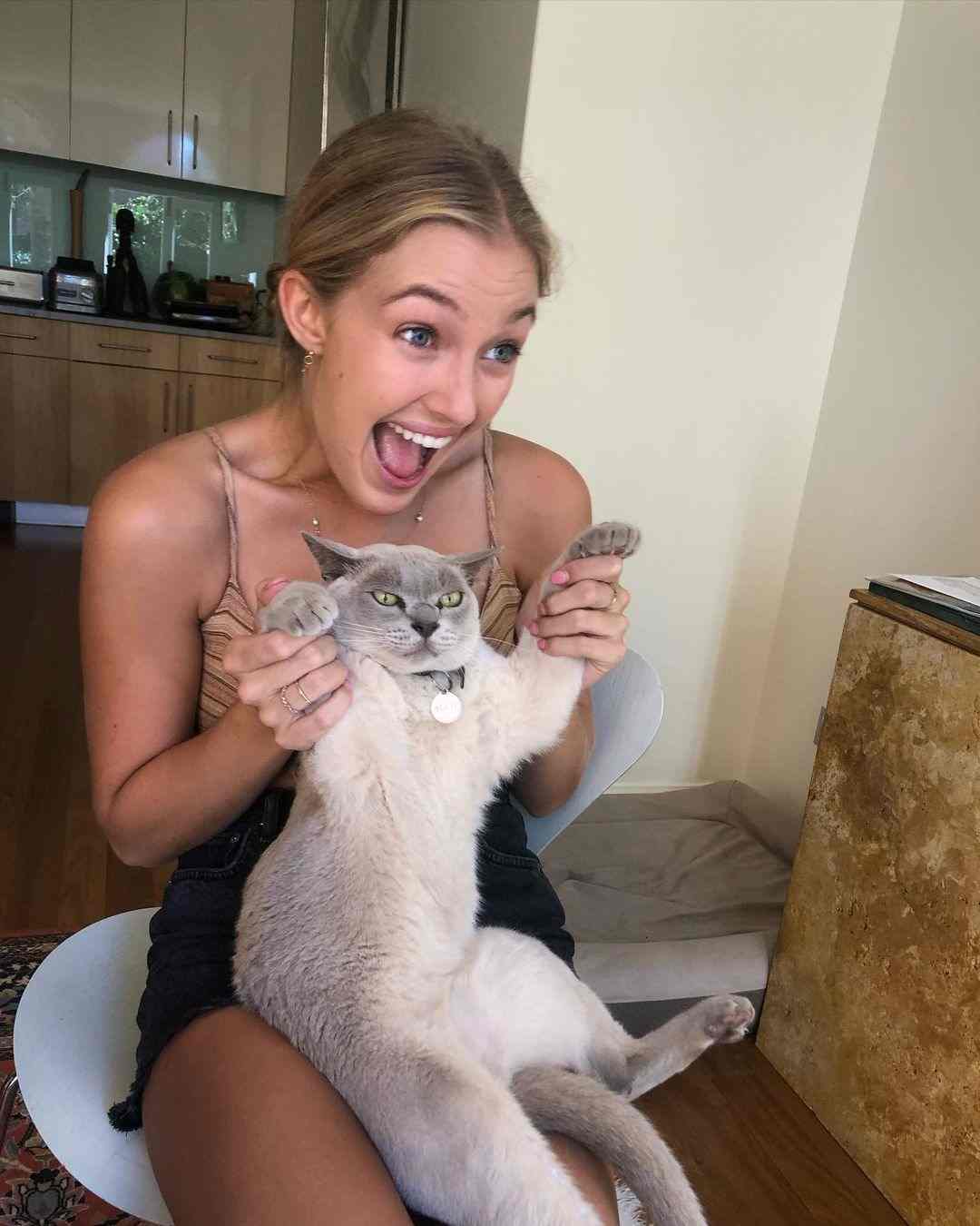 Sienna Weir playing with her cat, Alfie