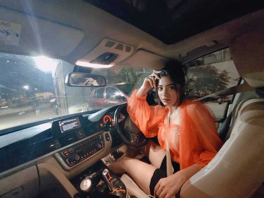 Snehal Rai sitting in her BMW car