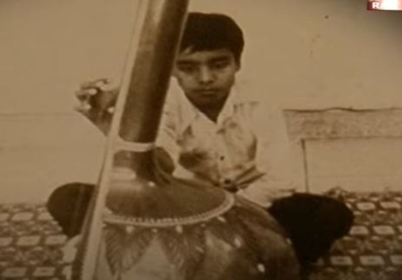 Wasifuddin Dagar holding a Sitar during childhood