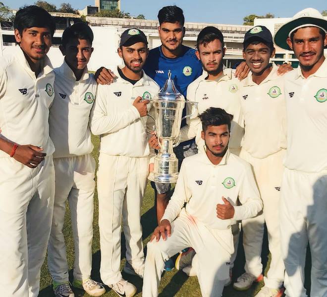 Yash Thakur and his teammates with the Cooch Behar Trophy