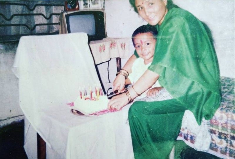 A childhood photo of Rohit Paudel with his mother