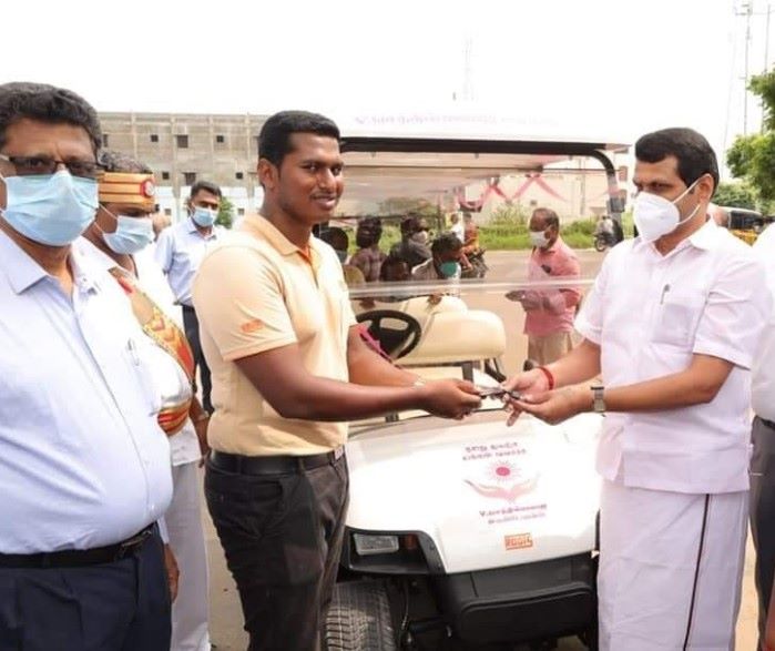 A photograph of V. Senthil Balaji handing over the keys of a vehicle to assist the differently abled people