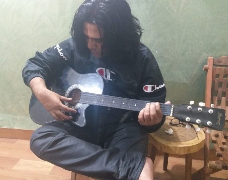 A. M. Turaz playing guitar
