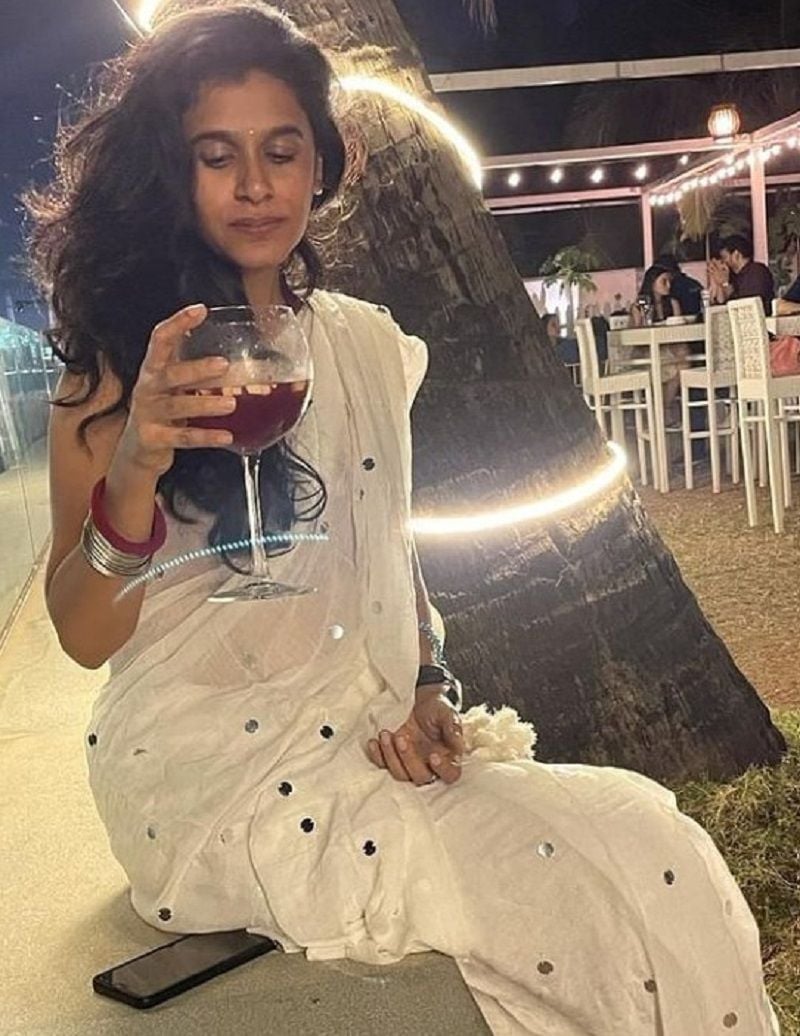 Adithi Kalkunte holding a glass of wine