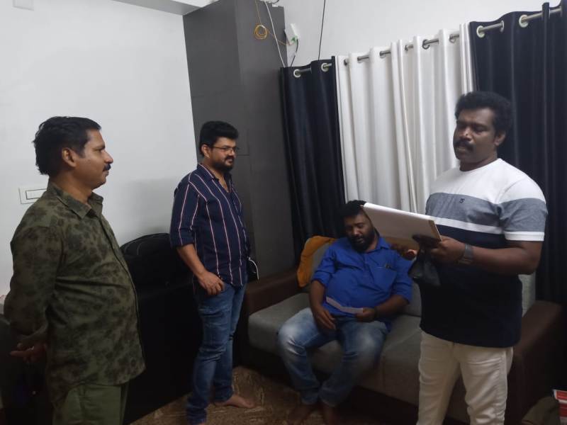 Binu Adimali (extreme right) reading a script of his film