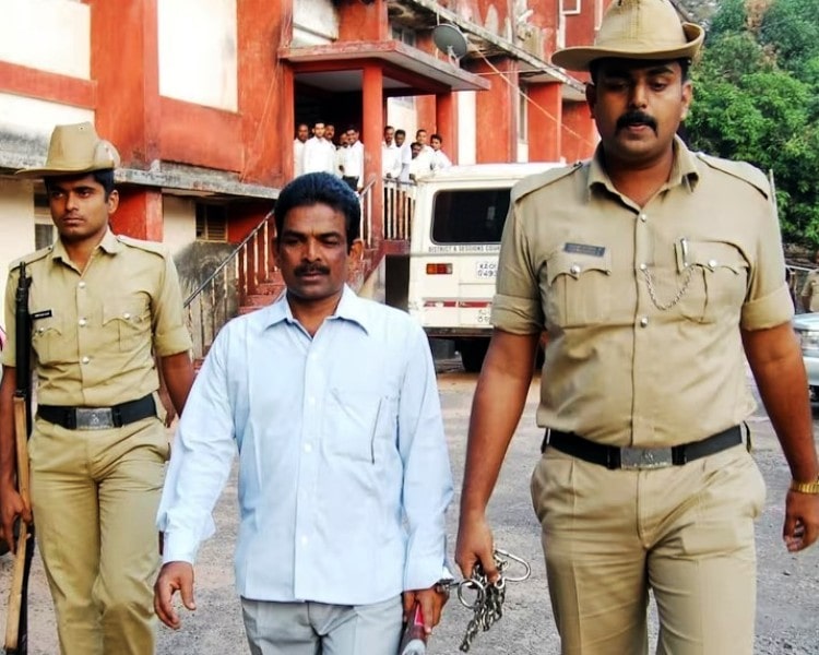 Cops escorting Mohan Kumar to a court