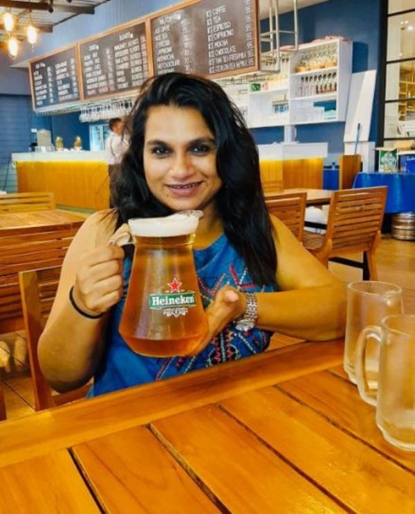 Geethi Sangeetha holding a beer mug