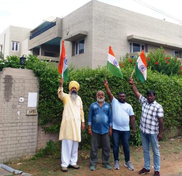 Members of the Indian National Congress (INC) holding the Indian flag outside Pannun's house in Chandigarh