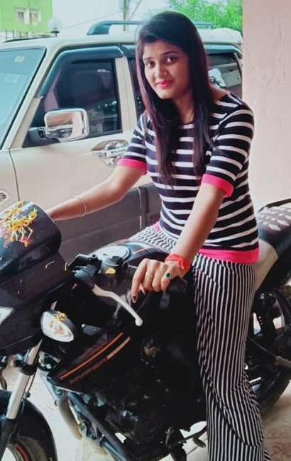 Nisha Upadhyay riding a motorcycle