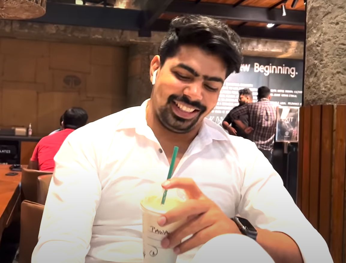 Pawan Sehrawat holding a a cup of coffee from Starbucks