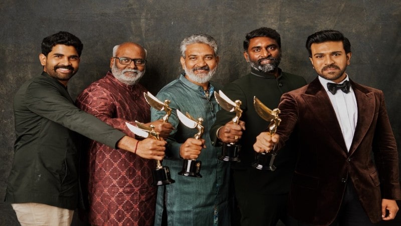 Ram Charan with team of RRR holding the Spotlight Award