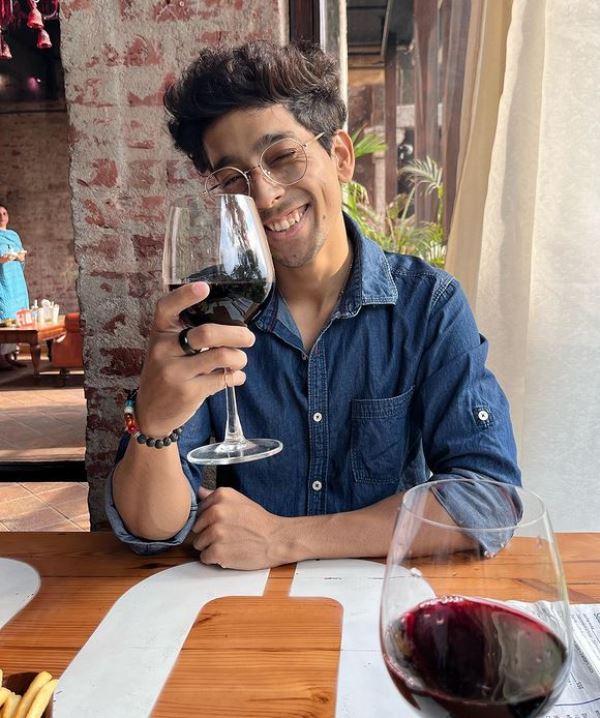 Shubham Chaudhary holding a glass of wine