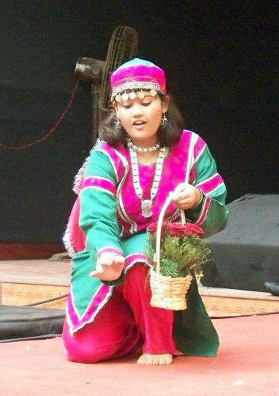 A childhood photo of Akshaya Naik performing at a school function