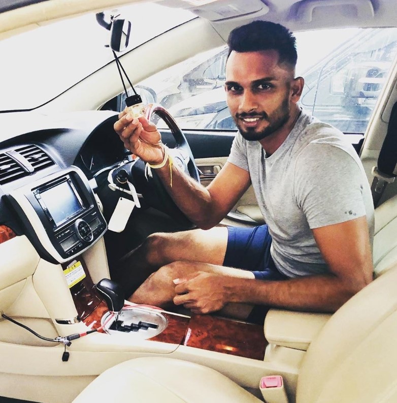 Dasun Shanaka posing in his car