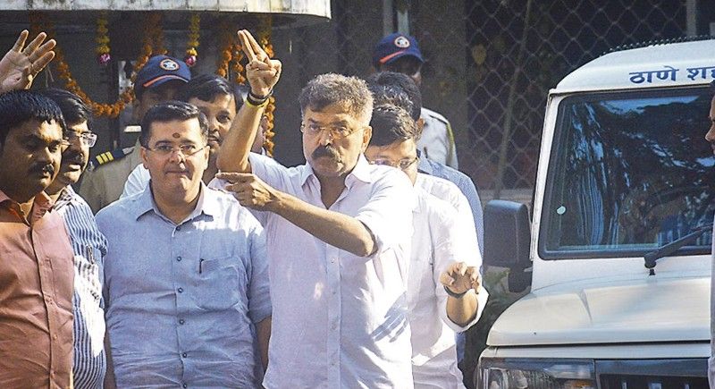 Jitendra Awhad waving to his supporters after coming out on bail