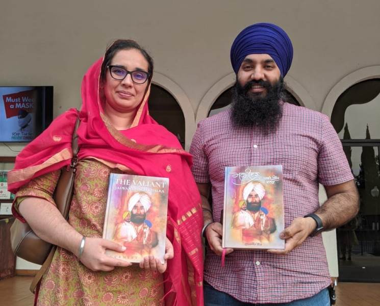 Navkiran Kaur and her husband, Dalbir Singh, posing with the book The Valiant - Jaswant Singh Khalra