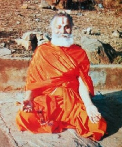 Rambhadracharya meditating on the banks of Mandakini river during a Payovrata