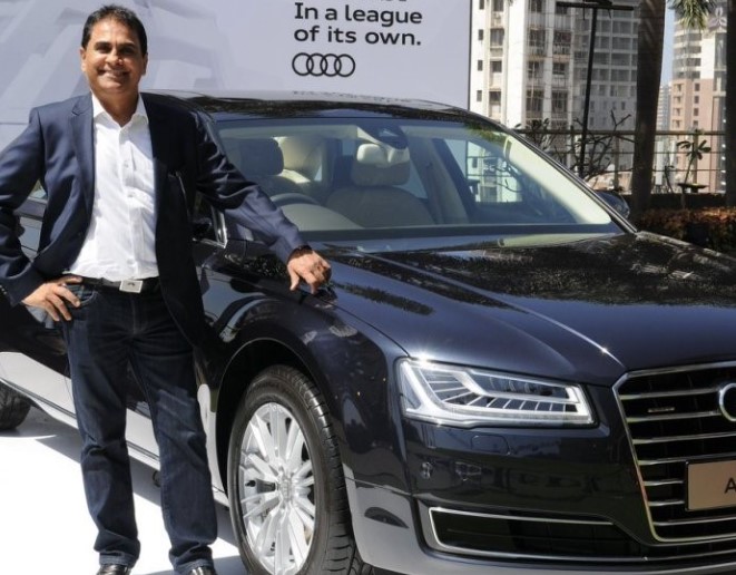 Vijay Kedia posing with his Audi