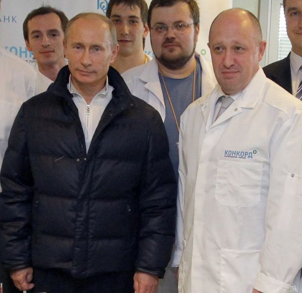 Yevgeny Prigozhin while giving a tour of Concord Catering factory to Vladimir Putin